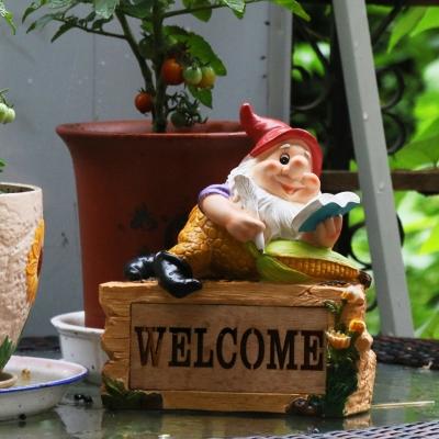 Farmhouse Elf Reading Resin Ground Lamp Portable Solar LED Pathway Light in Yellow